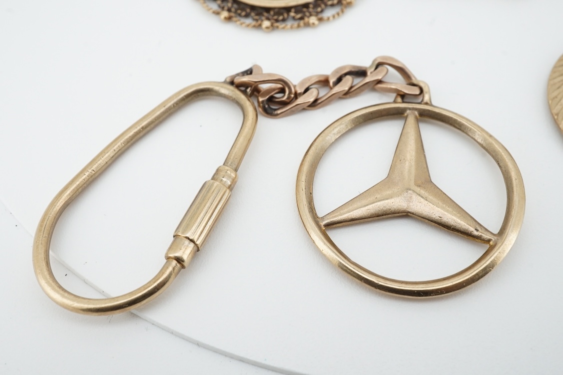 A modern 9ct gold Star of David pendant, diameter 22mm, a 9ct gold St Christopher's pendant on a 9ct chain and an Italian Uno-A-Erre 9k Mercedes insignia keyring, gross weight 22.2 grams.